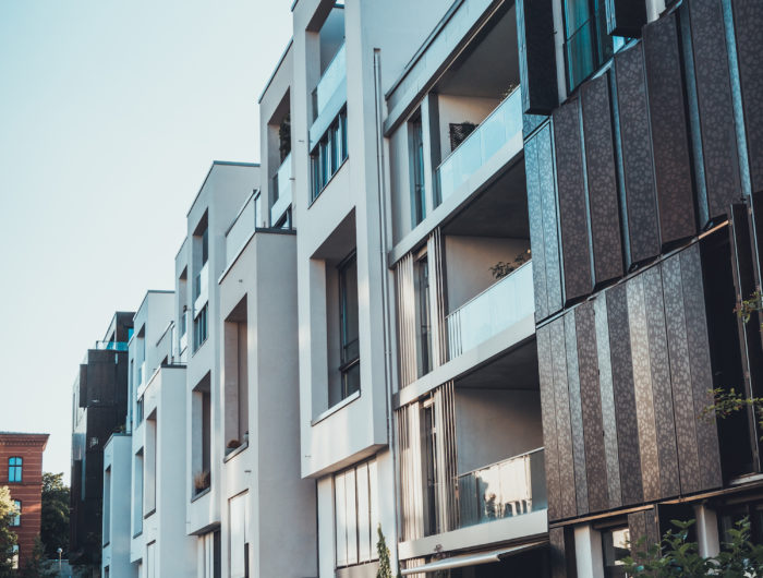 Street view of modern apartment blocks Street view of a row of modern apartment blocks or townhouses in a oblique angle receding perspective